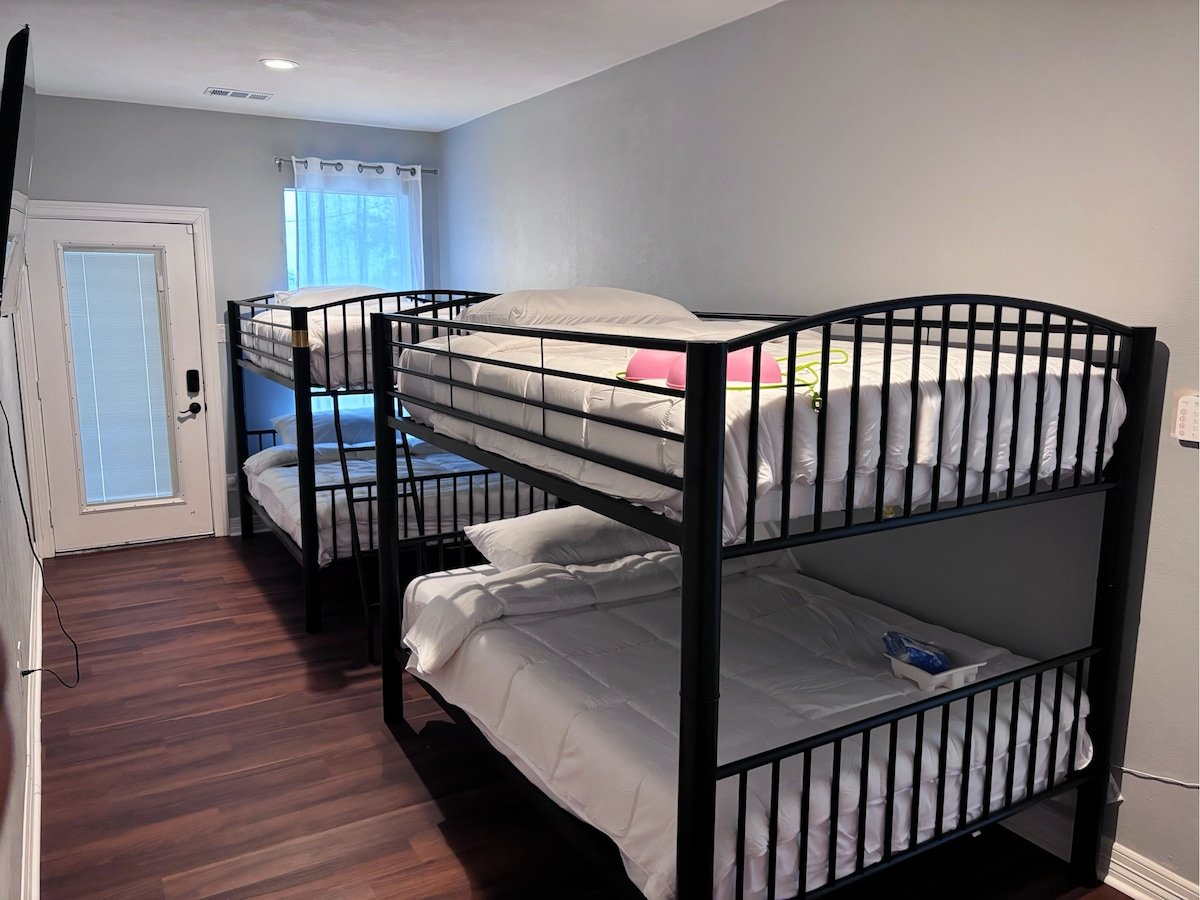 Kids bunk room with 4 queen-sized beds and smart TV