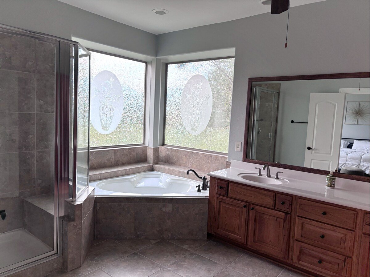 Master Suite Jacuzzi, walk-in shower, and vanity