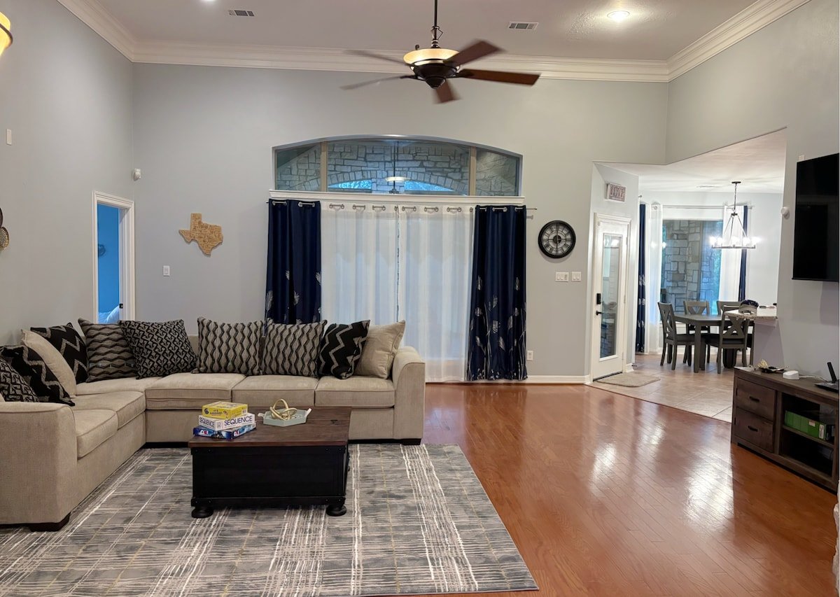 Large living room with backyard views and game boards